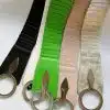 Sechs stilvolle Flexible Guertel in verschiedenen Farben und Strukturen mit großen runden Ringen und daran befestigten Metallanhängern auf weißem Hintergrund, die sich perfekt als Ergänzung zu Ihren Flex Gürtel-Accessoires eignen.