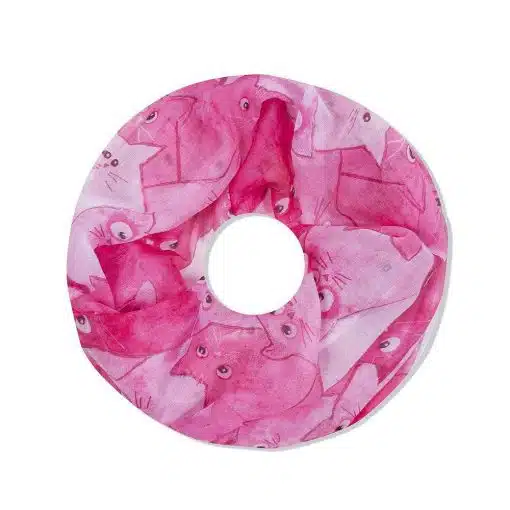 Ein rundes rosa Nackenkissen im Design eines Cat Loop Schals, bedeckt mit einem Muster aus Cartoon-Katzengesichtern von oben betrachtet, mit einem Loch in der Mitte und sichtbaren Nähten an den Rändern.