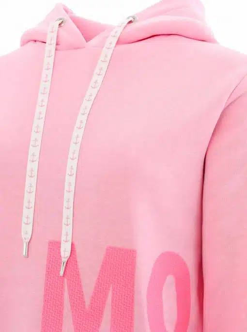 Nahaufnahme eines rosafarbenen Kapuzenpullovers mit weißen Kordeln, die kleine Ankermuster aufweisen. Der rechte Brustbereich zeigt eine teilweise rosafarbene Textgrafik mit den Buchstaben „MO“. Der Kapuzenpullover verfügt über Metallösen an den Kordellöchern.