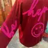 Zieh dieses leuchtend rote "Be Happy" Sweatshirt an und bring gute Laune in deinen Tag! Mit dem modernen pinken Schriftzug und dem coolen Smiley mit Sternaugen ziehst du alle Blicke auf dich und setzt ein Statement für Positivität. Fühl dich rundum wohl - sei mutig, sei du selbst, sei glücklich!.