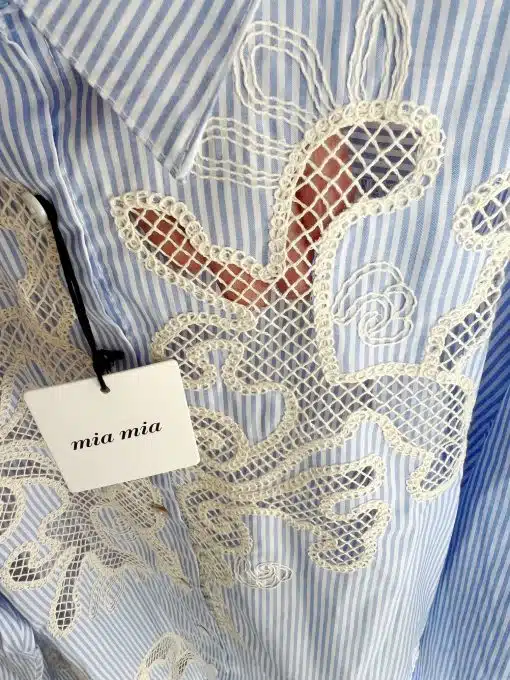 Entdecke deine Seaside Bluse: Blaue und weiße Streifen, feine Spitzen-Details und das edle "mia mia"-Tag als Hingucker.