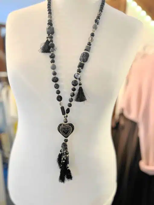 Trage die Soul Heart Statement-Kette: Lange, schwarze Perlen, Herzanhänger und Tasseln - dein modernes Highlight am Dekolleté.