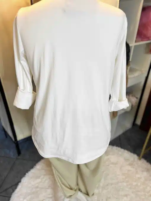 Entdecke deinen modernen Look: Zieh das langärmelige weiße Shirt und die beigen Hosen an - stylisch und zeitlos!.