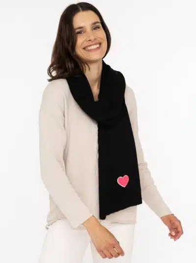 Du strahlst in deinem beigen Pullover und stylischen schwarzen Schal mit süßem pinkem Herz - so modern wie du selbst!.