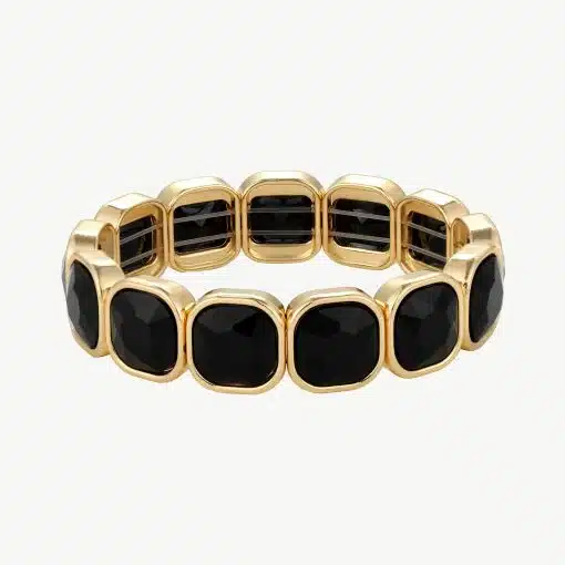 Erlebe, wie das goldene Armband mit markanten schwarzen Edelsteinen deinen Look modern und luxuriös in Szene setzt.