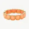 Erlebe modernen Luxus: Trage dieses goldene Armband mit leuchtend orangen Steinen und setze ein stylishes Statement!.