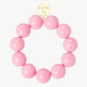 Entdecke dein stylisches GIUNO Armband aus großen pinken Perlen mit edlem Gold-Tag - verleihe deinem Look das gewisse Extra!