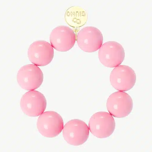 Entdecke dein stylisches GIUNO Armband aus großen pinken Perlen mit edlem Gold-Tag - verleihe deinem Look das gewisse Extra!.
