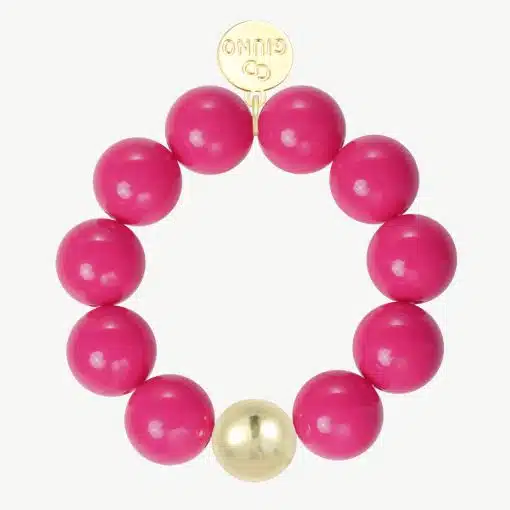 Erlebe dein Fashion-Upgrade mit dem GIUNO Armband: Knallige pinke Perlen, ein goldenes Highlight und runder Charme für deinen Look!.